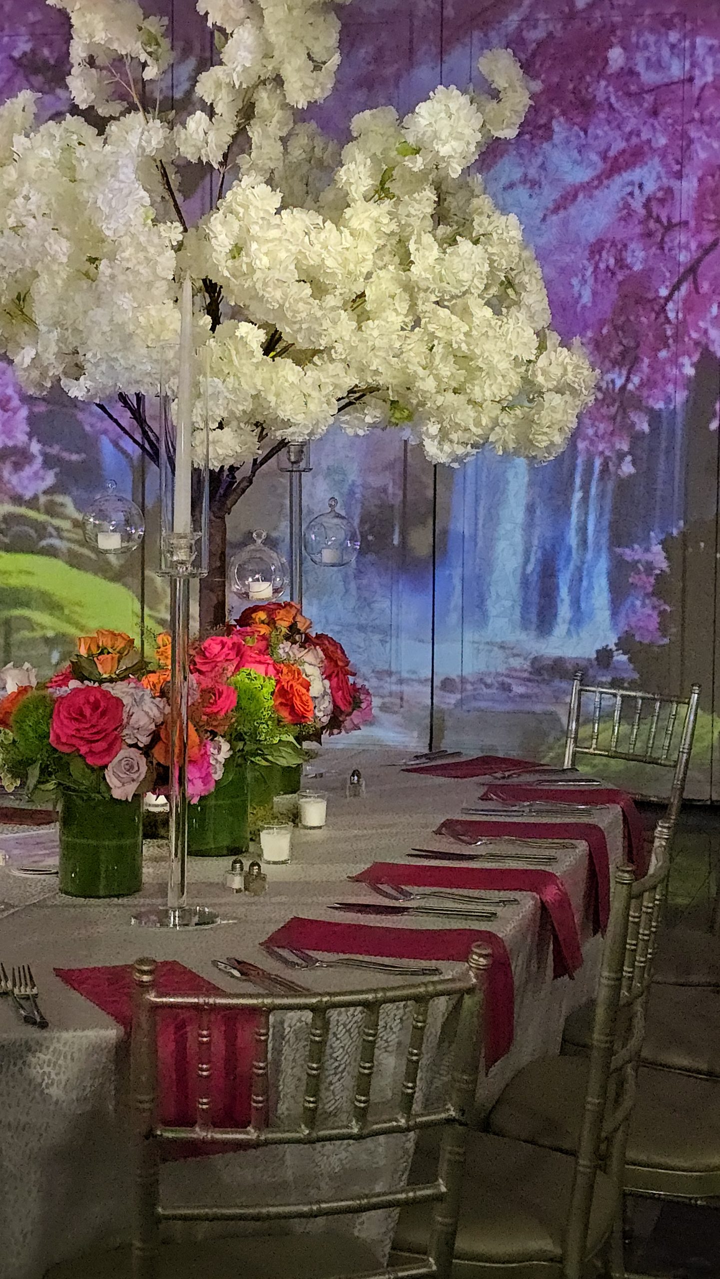 Blossom trees over the tables, the waterfall wall beyond