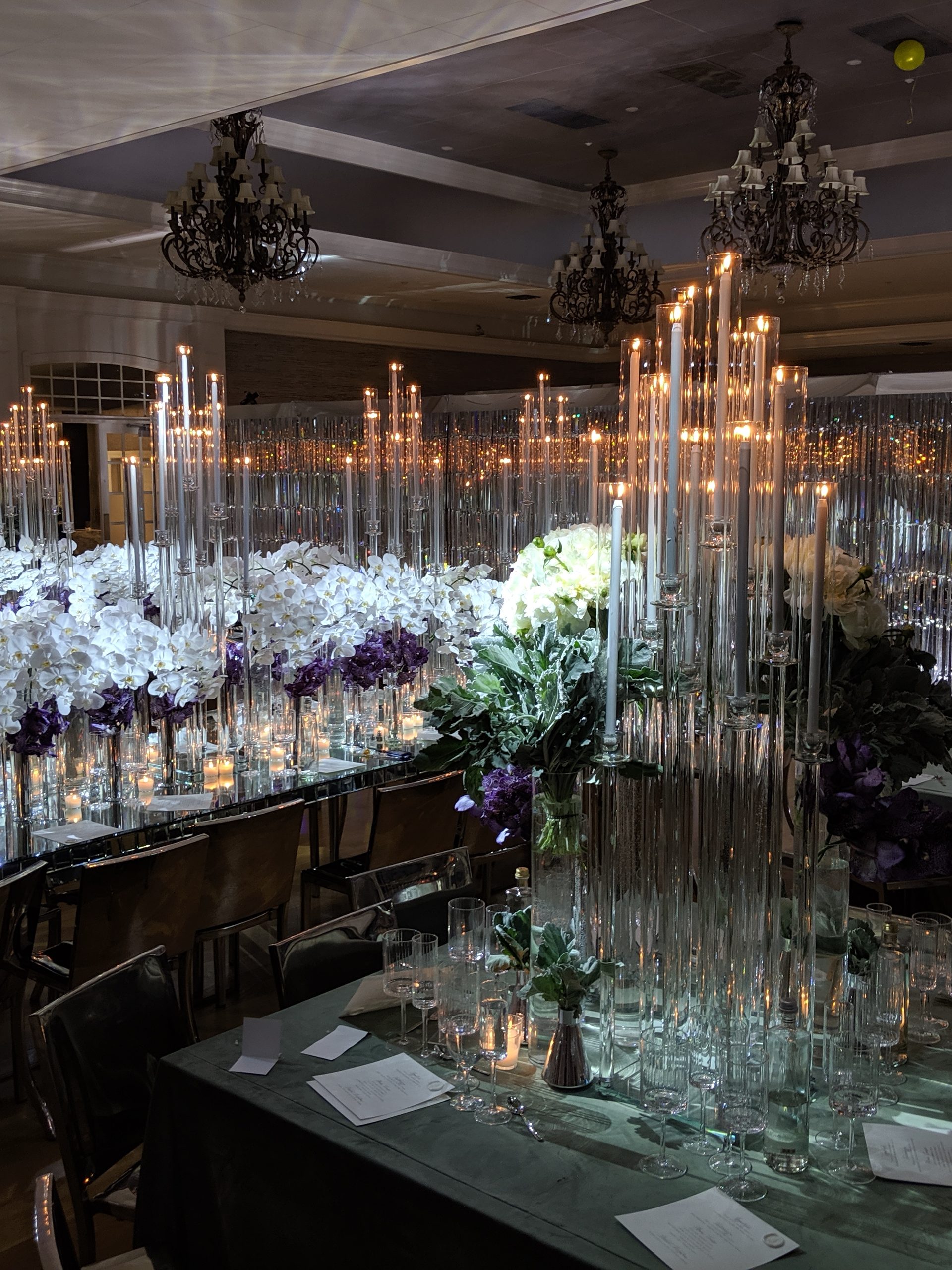 The whole room: the crystal curtain on every wall, tapers over every table, chandeliers above