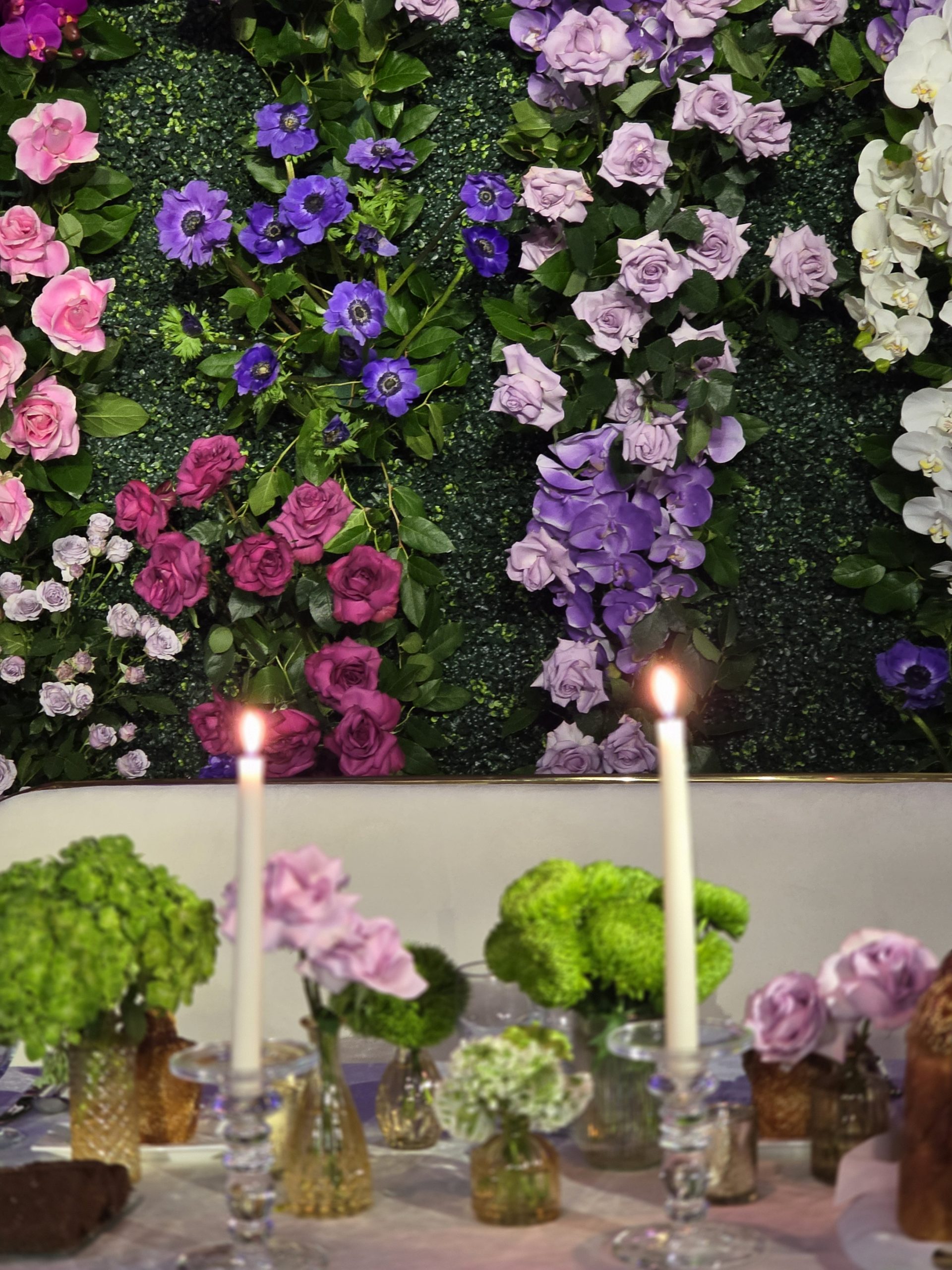 The flower wall close: pink, purple and white blooms