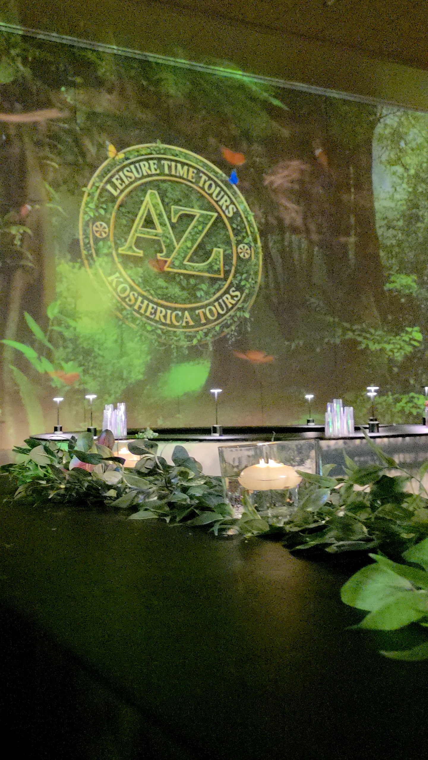 Greenery and florals against the projected forest