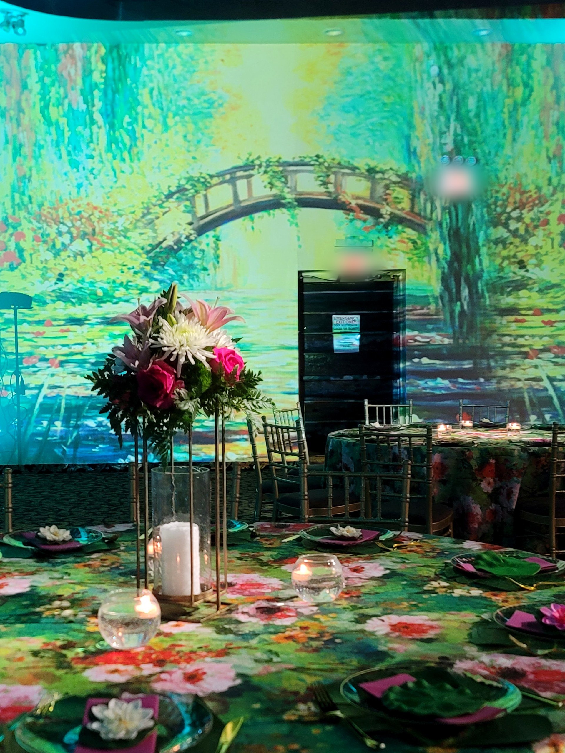The Japanese bridge projected on the wall, a tall arrangement in front