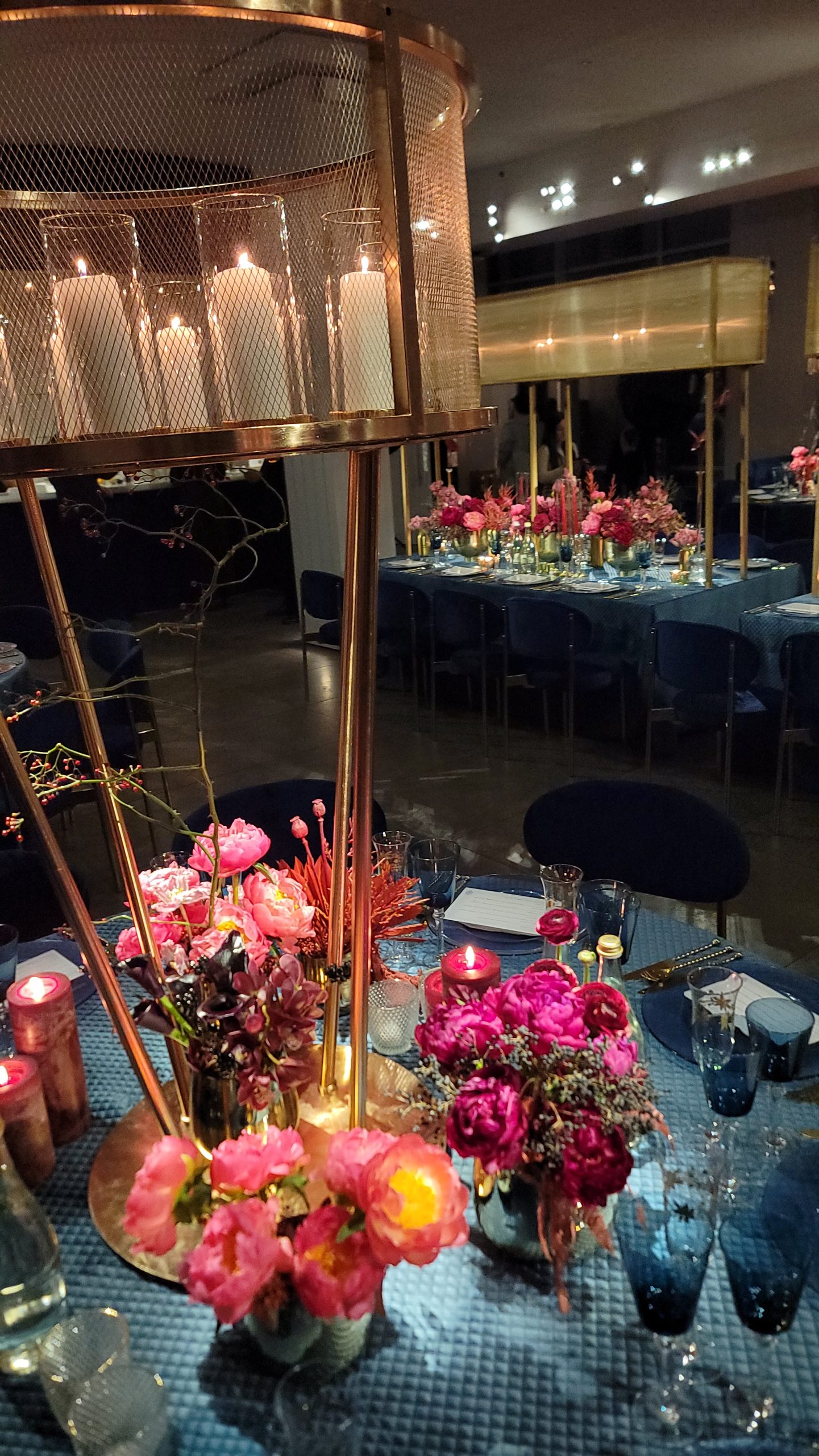 The candle cages over the tables, the florals in copper, the room lit low