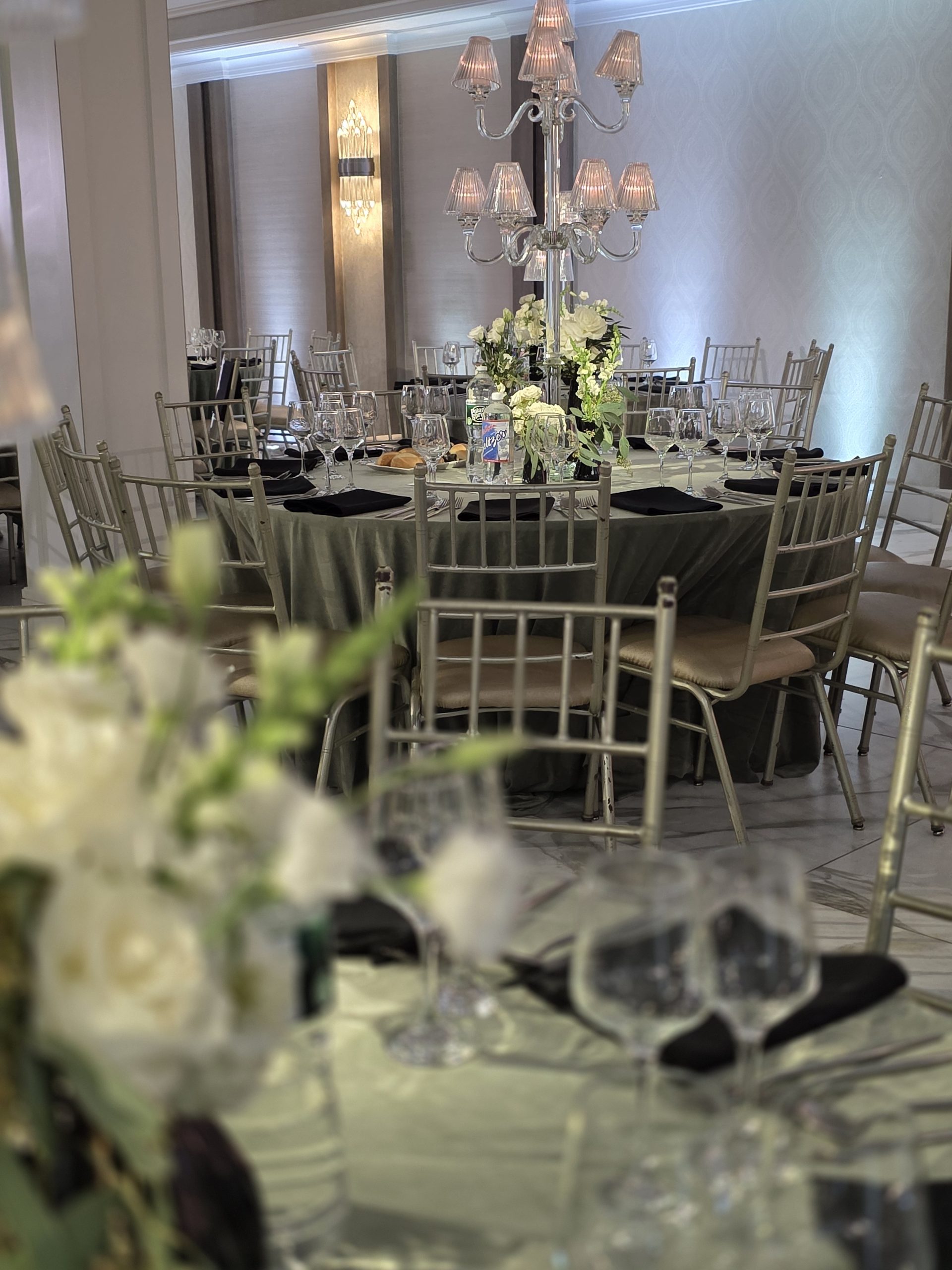 The candelabra and the white florals at a table edge, the chairs in gold