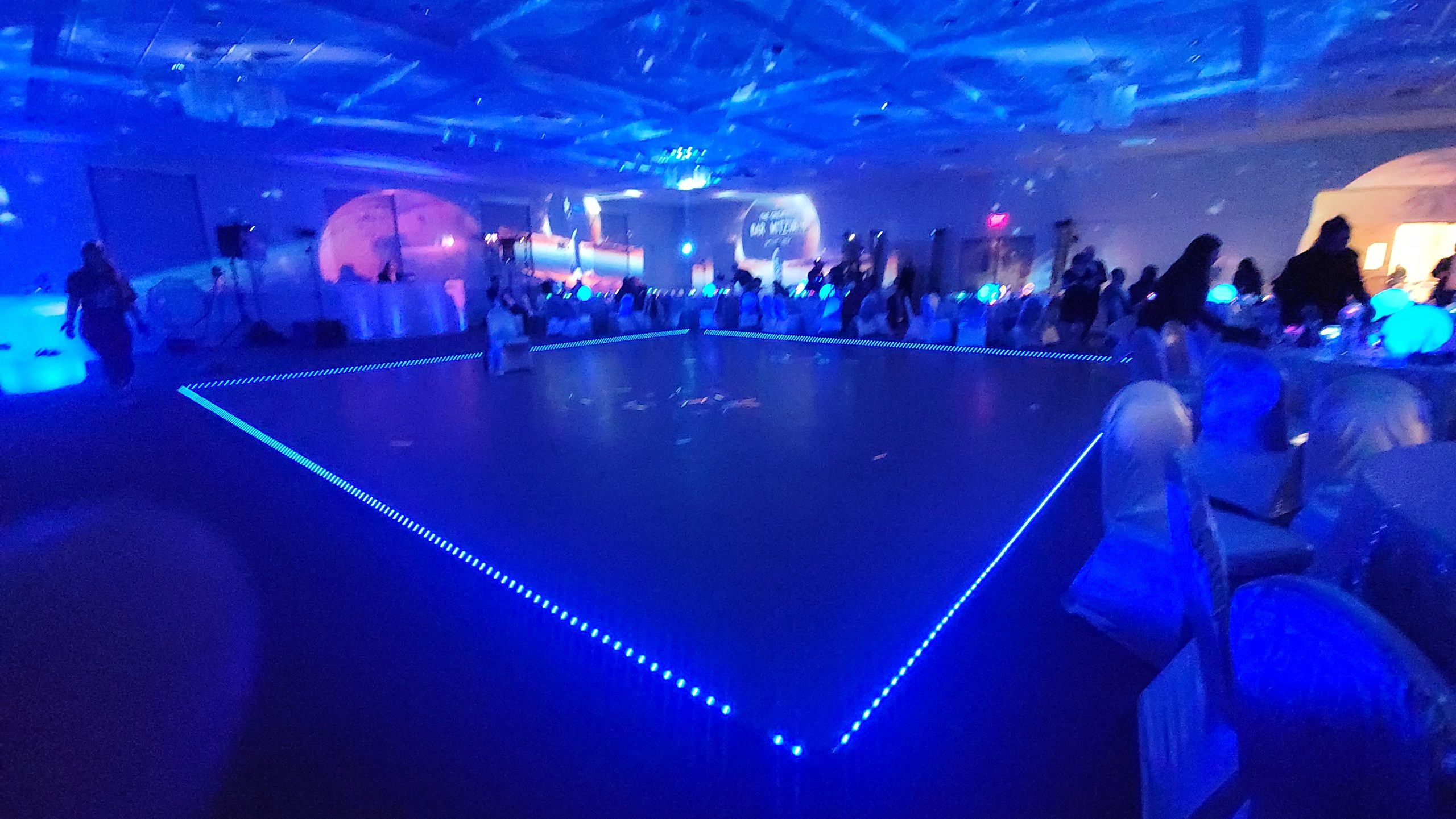 The dance floor edged in blue light, planets on every wall and the ceiling