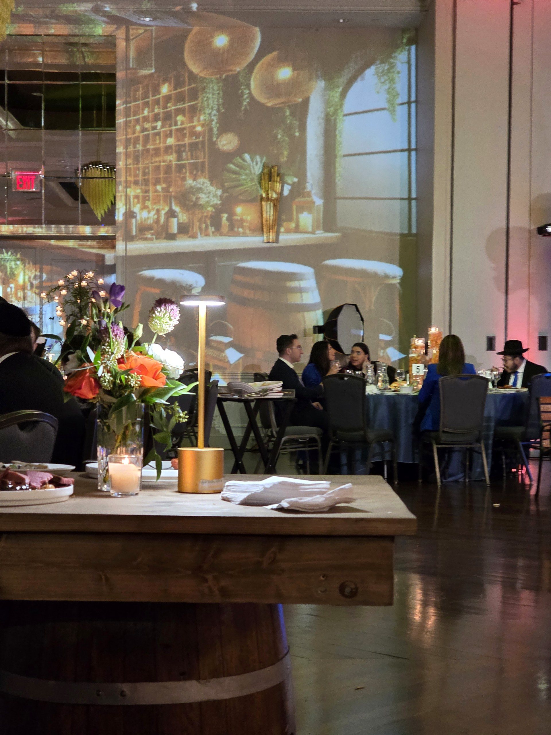 The dinner: a night café street projected on the wall, a lamp post at the table