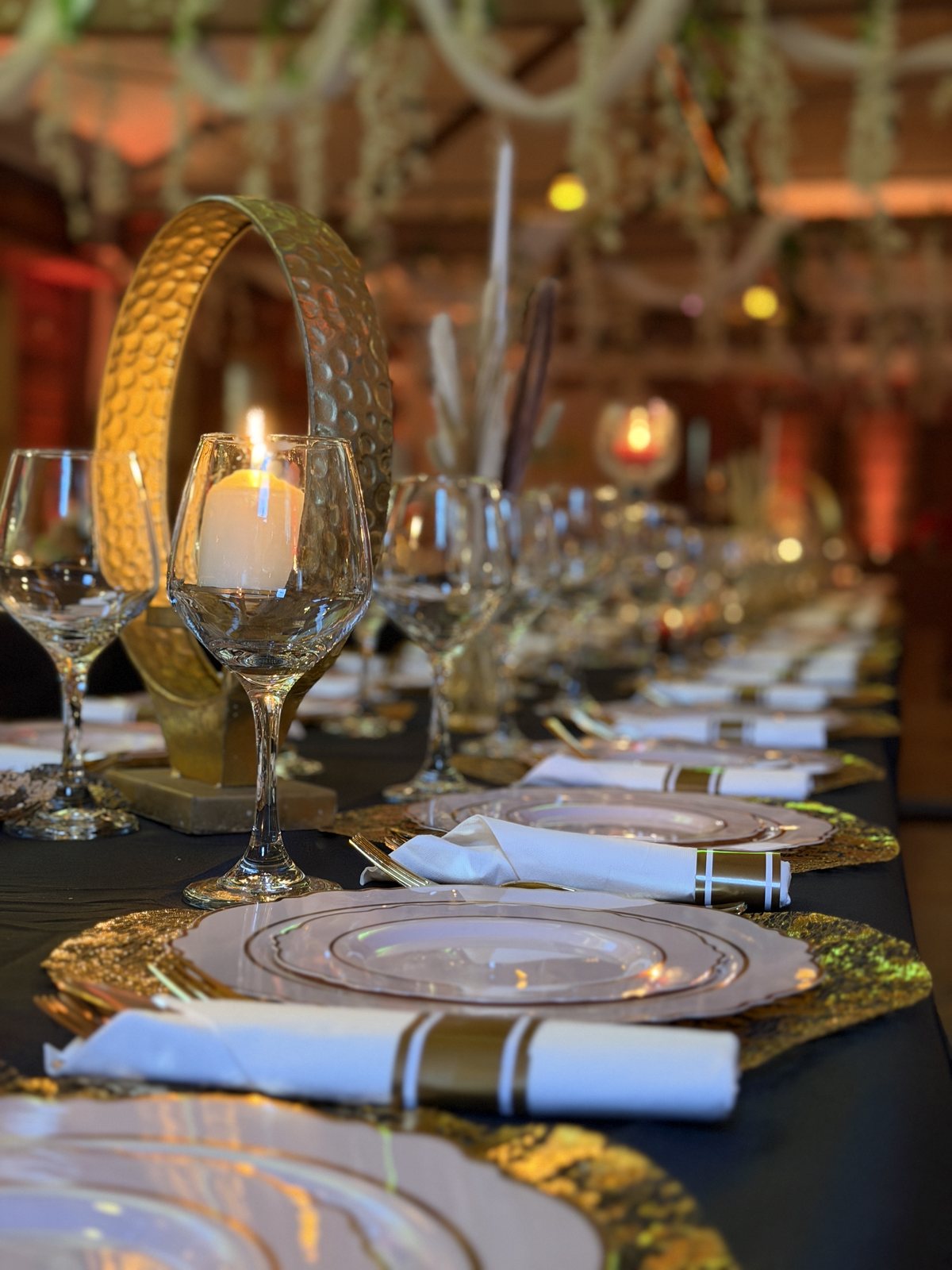 Gold chargers and candlelight down a long table