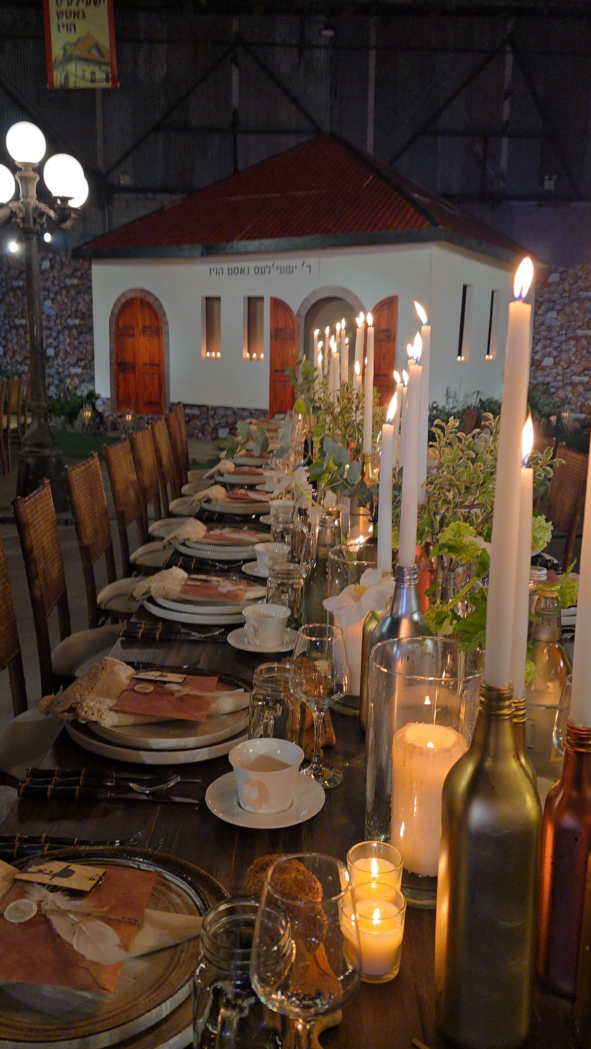 Tall white tapers down a long dinner table