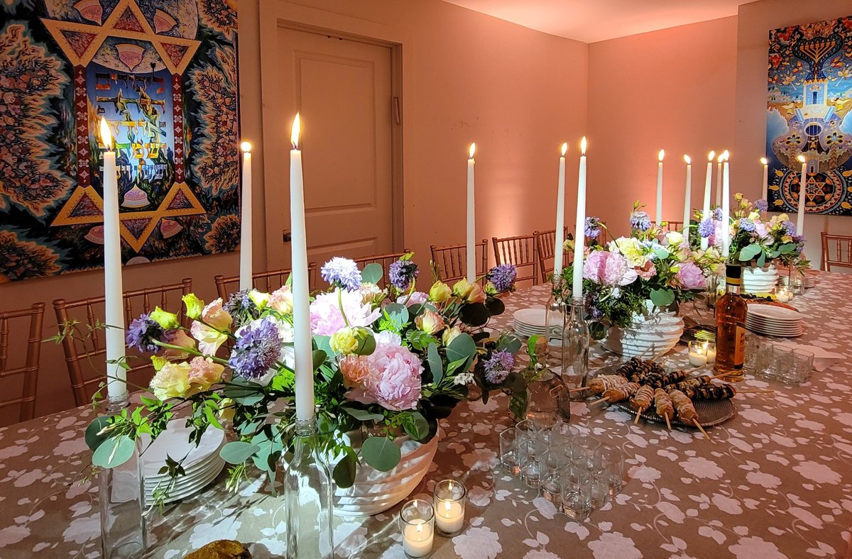 Pink and lilac florals with white tapers down a long table
