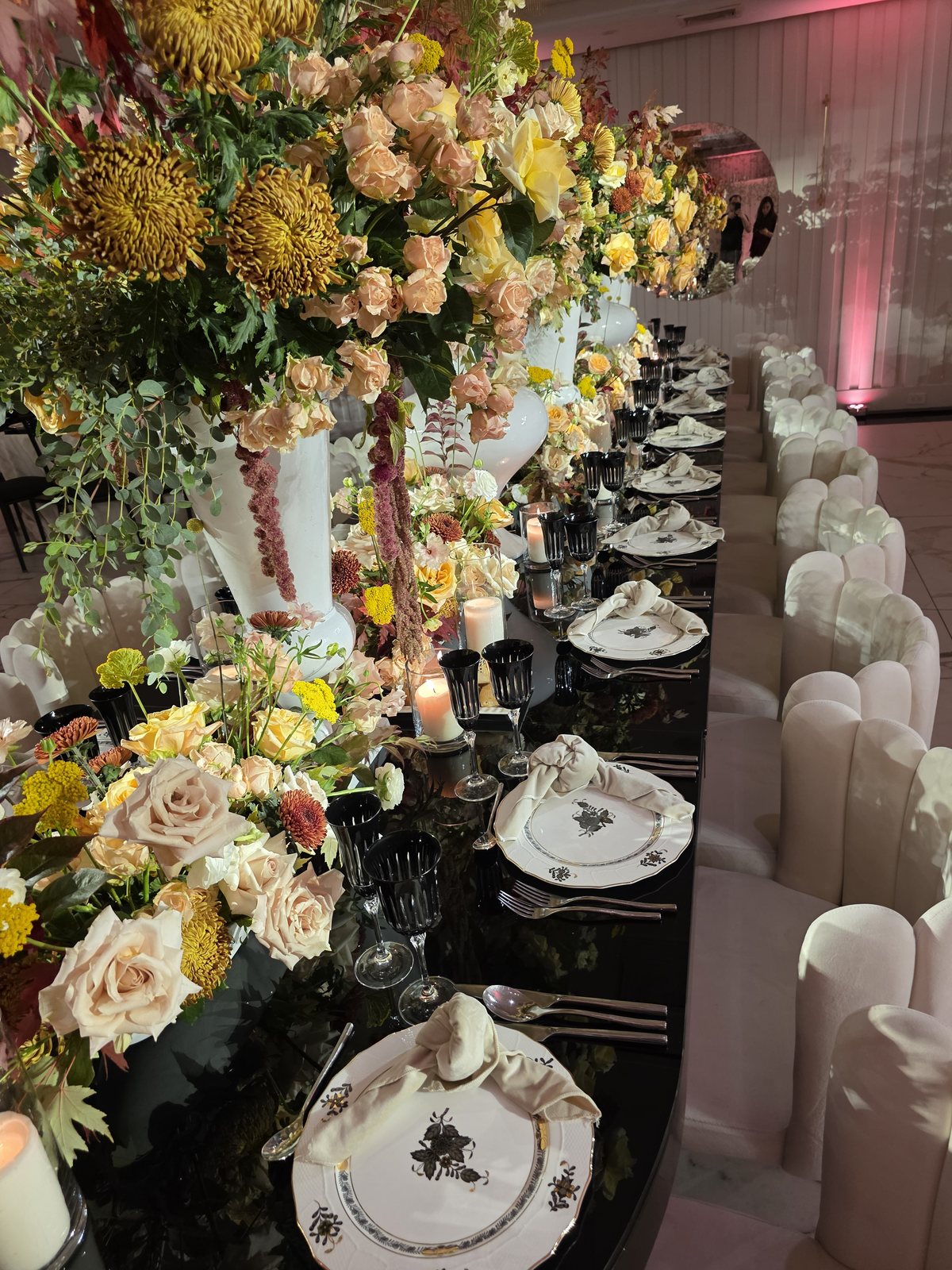 Yellow and white roses down a long table set in white