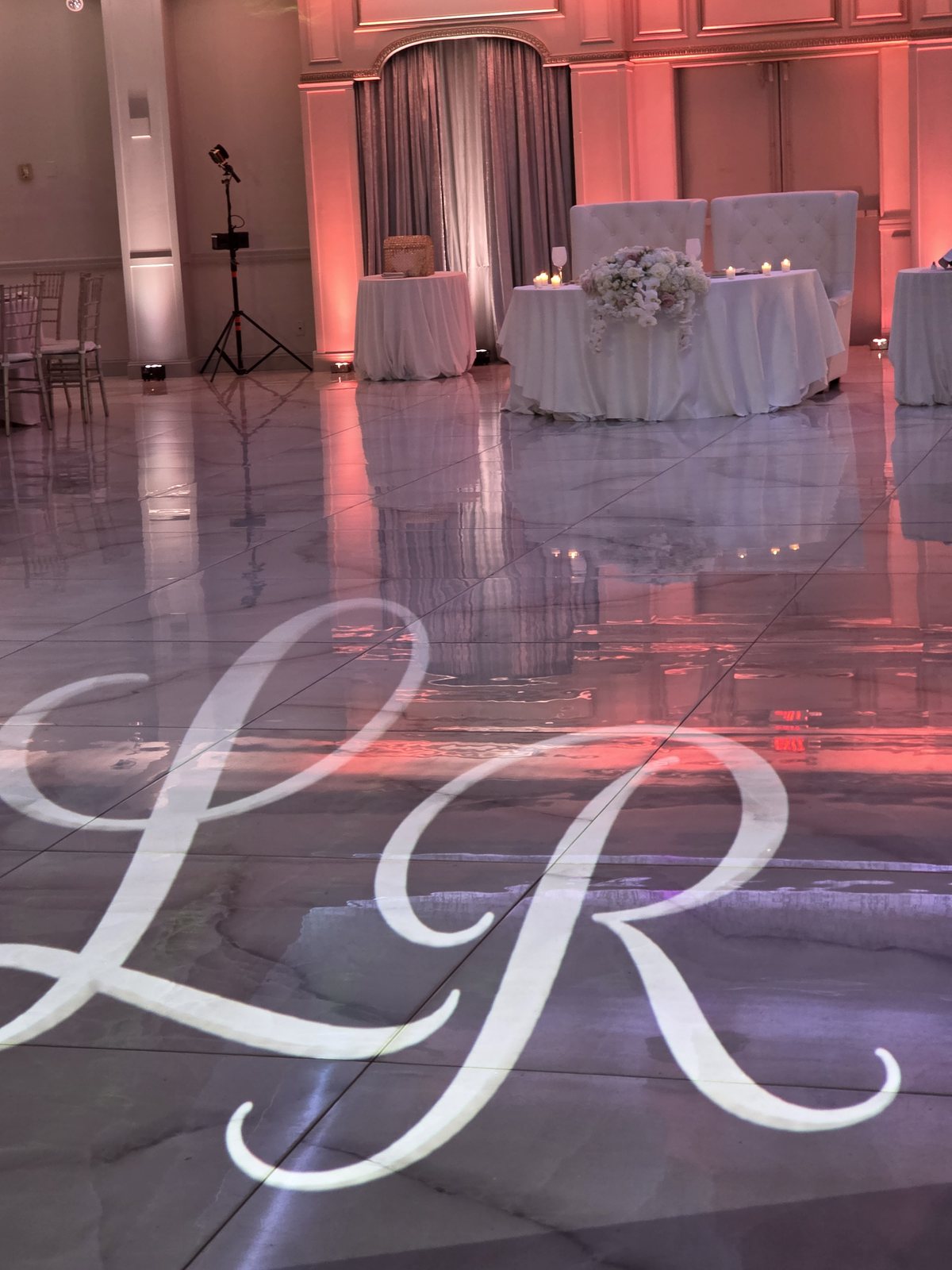 The couple's initials in light on the dance floor