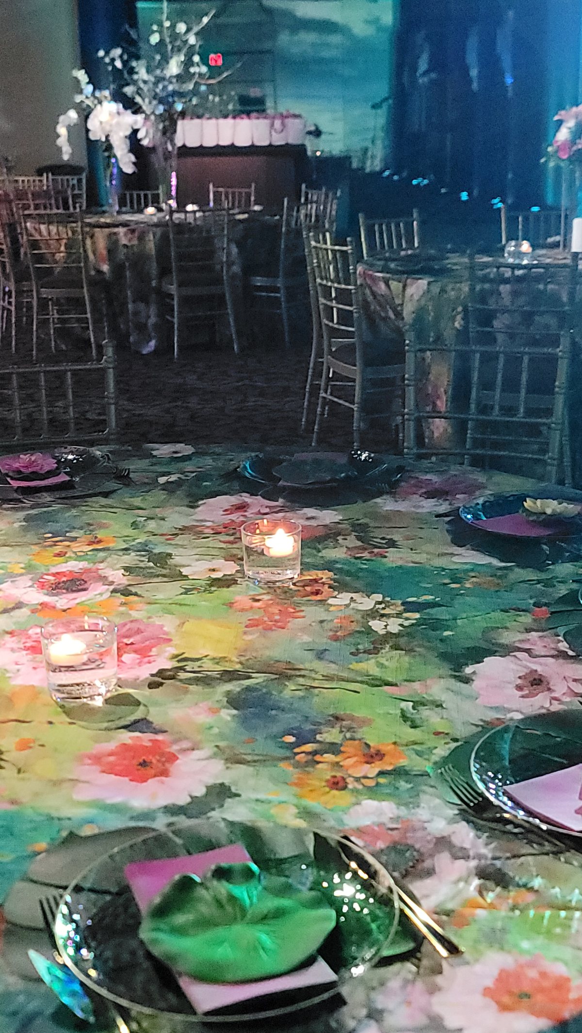 Water lilies projected across the floor between the tables